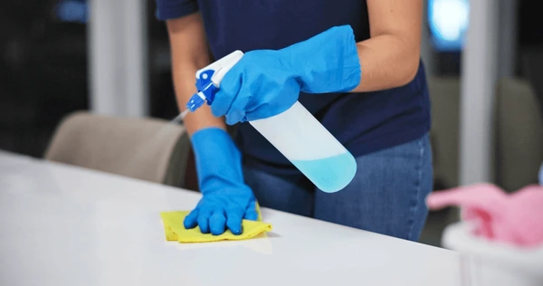 Person cleaning and disinfecting their home after flood damage
