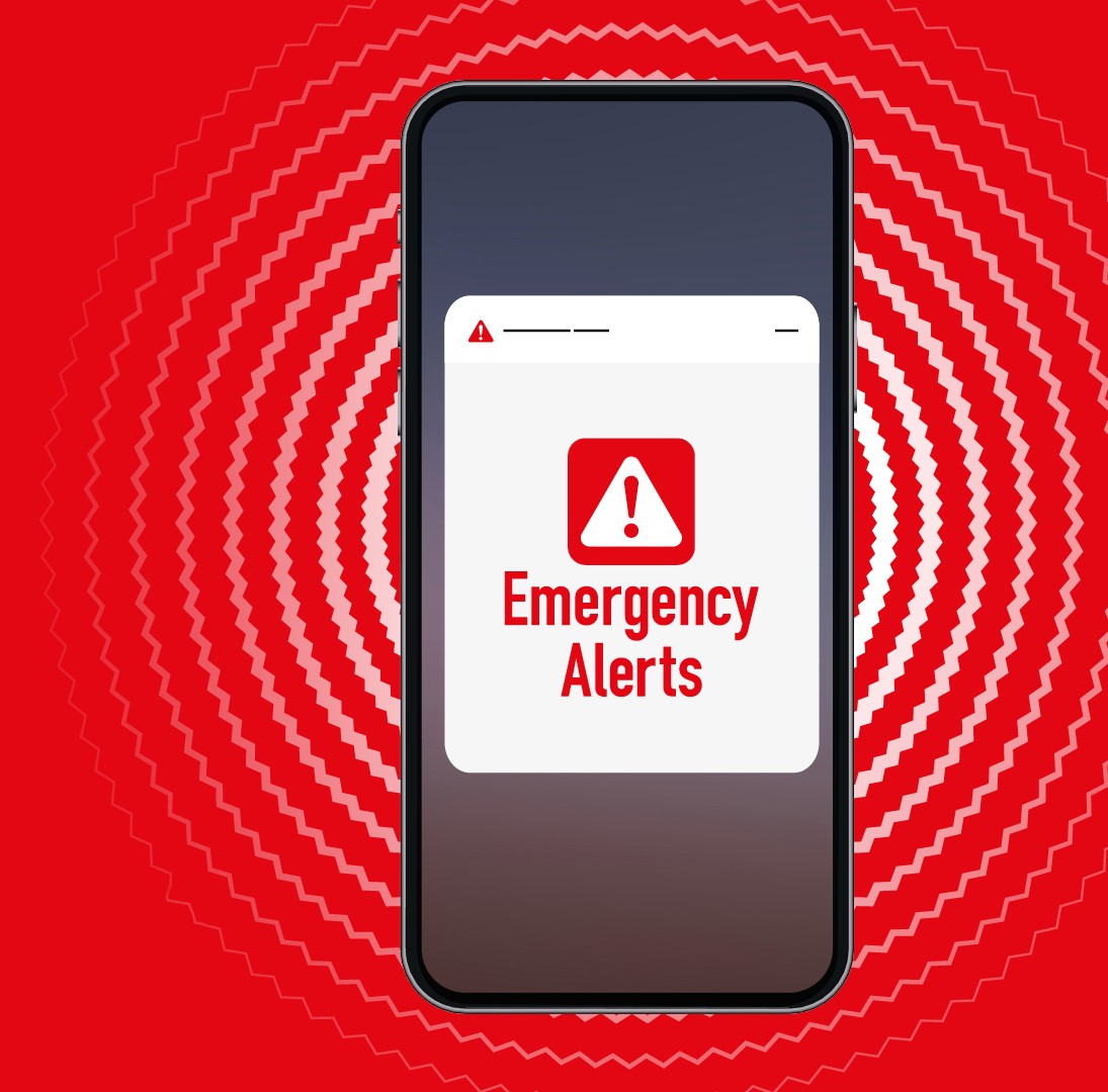 Person listening to emergency alerts on a battery-powered radio